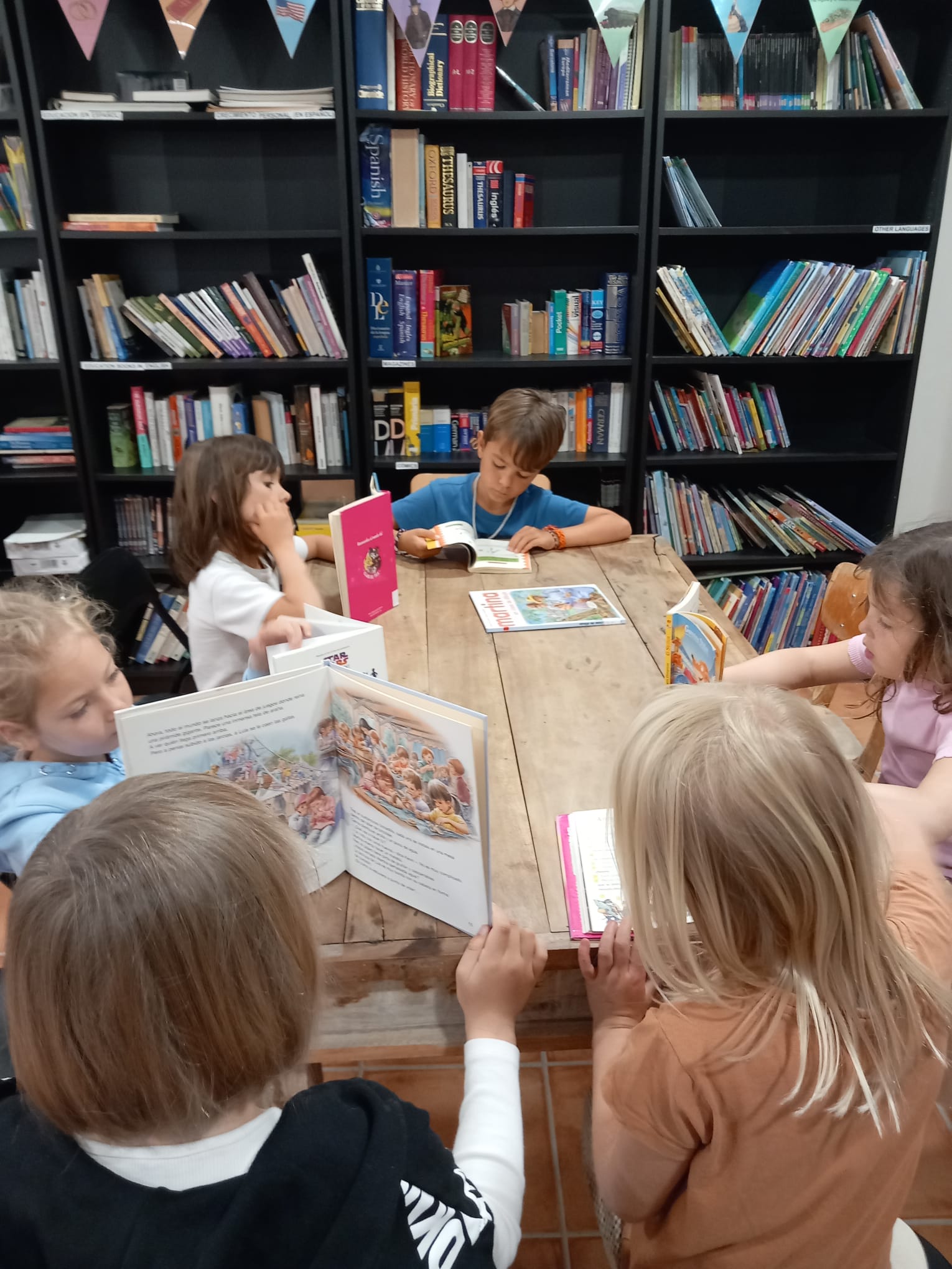 Primary students reading at the library